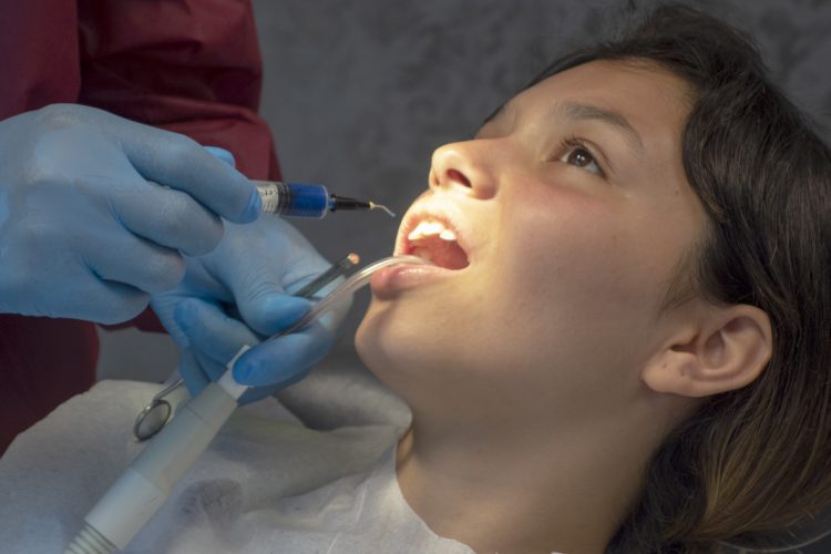 Operation with dental or dental hygienist patient. Woman with calculus or bruise. Oral Doctor wisdom tooth removal. Dentist. Expert business. -